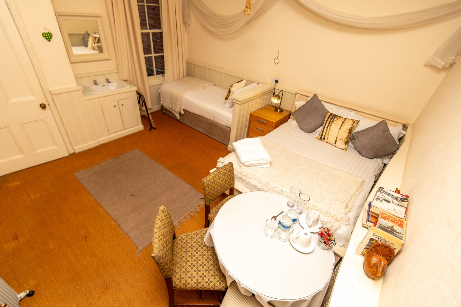 Deluxe Double Room interior at Cornerstones Guest House Sale Manchester showing individually styled boutique décor double bed seating area and Victorian charm