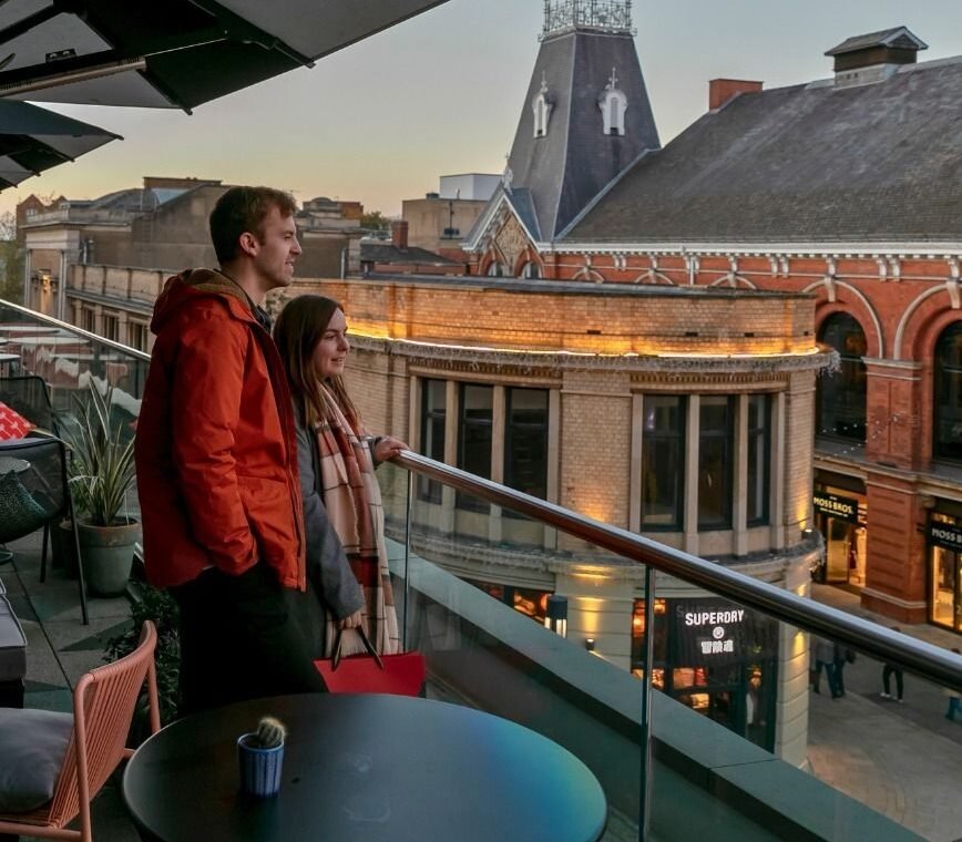 Manchester couples enjoying a romantic evening in Ancoats canal side with the John Rylands Library and Spinningfields rooftop bar in Manchester city centre